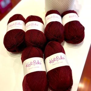 Six skeins, balls of knit picks Brava worsted yarn. Color currant, lot 1402